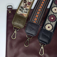 Guitar Bag Strap collection featuring decorative woven prints and leather trims on a maroon handbag.