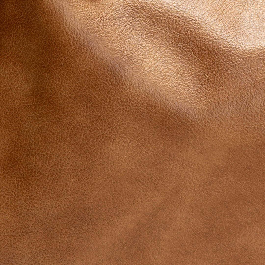 Close-up of luxurious golden tan leather used in the Original Lauren leather crossbody bag.
