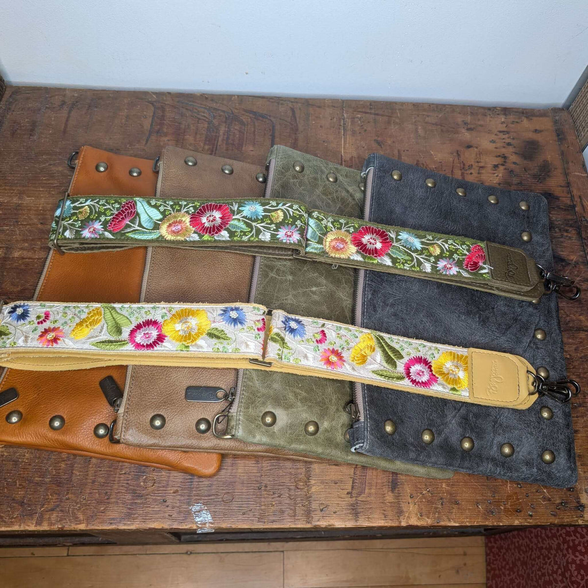 Lizzy Guitar Bag Strap - Evergreen Wildflowers on leather handbags, showcasing guitar purse strap with colorful floral design.